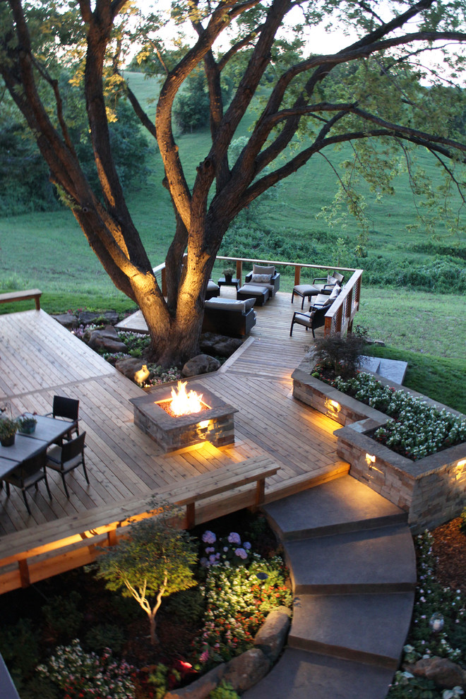 Design ideas for a large contemporary backyard deck in Kansas City with a fire feature and no cover.