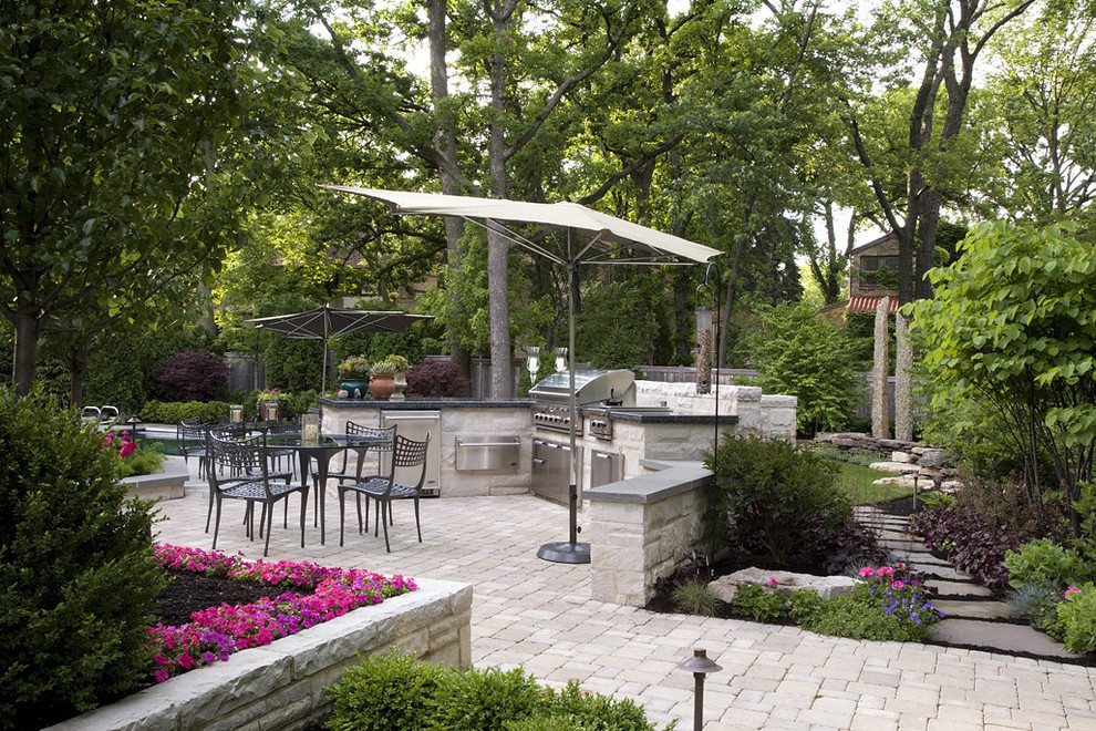 Large traditional backyard patio in Chicago with concrete pavers, an outdoor kitchen and no cover.