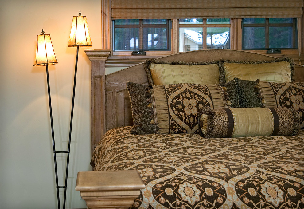 Example of a large mountain style guest carpeted bedroom design with beige walls and no fireplace