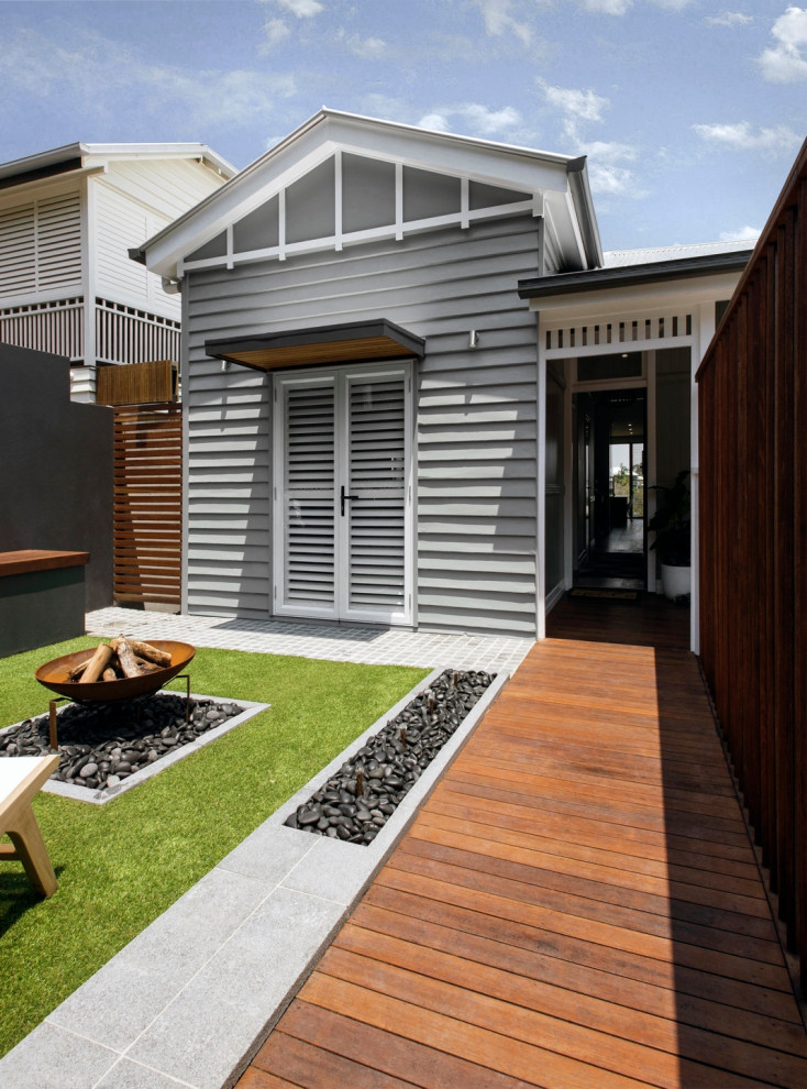 Contemporary front yard full sun garden with a fire feature and decking.