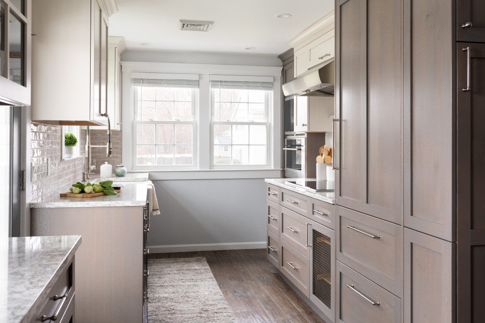 Photo of a country galley kitchen in Boston with shaker cabinets, brown cabinets, grey splashback and dark hardwood floors.
