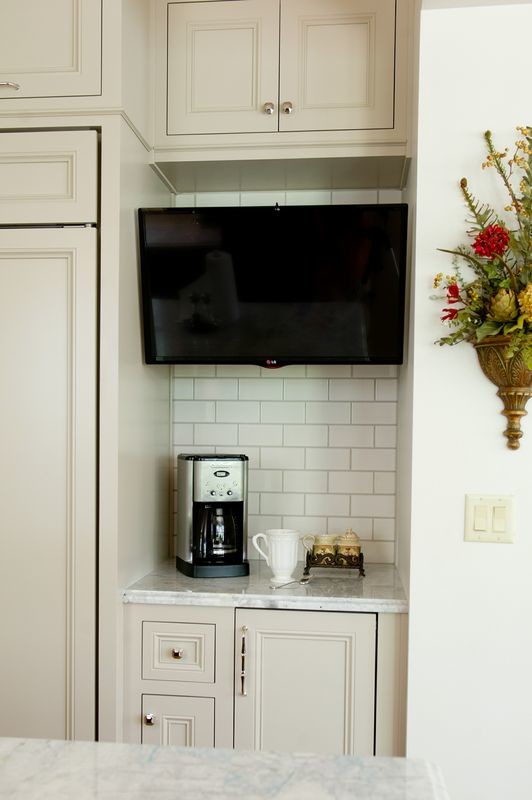 Transitional medium tone wood floor kitchen photo in Atlanta with a farmhouse sink, beige cabinets, quartzite countertops and an island