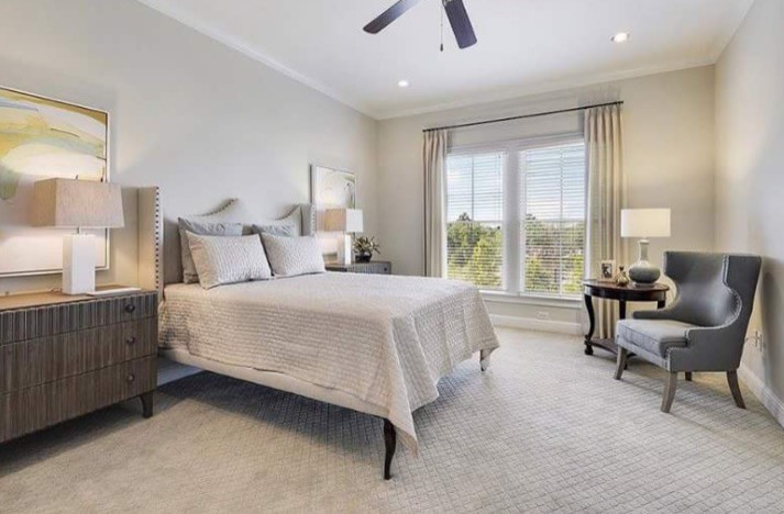 Inspiration for a mid-sized transitional master bedroom in New Orleans with grey walls and carpet.
