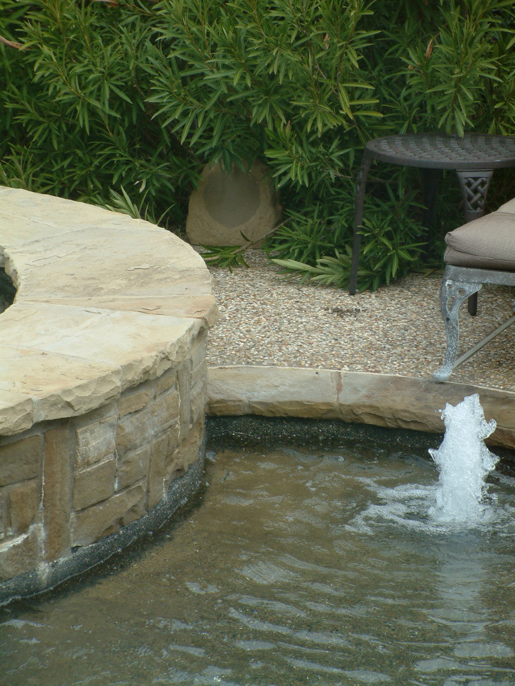 Inspiration for a traditional backyard rectangular lap pool in Dallas with a hot tub and gravel.