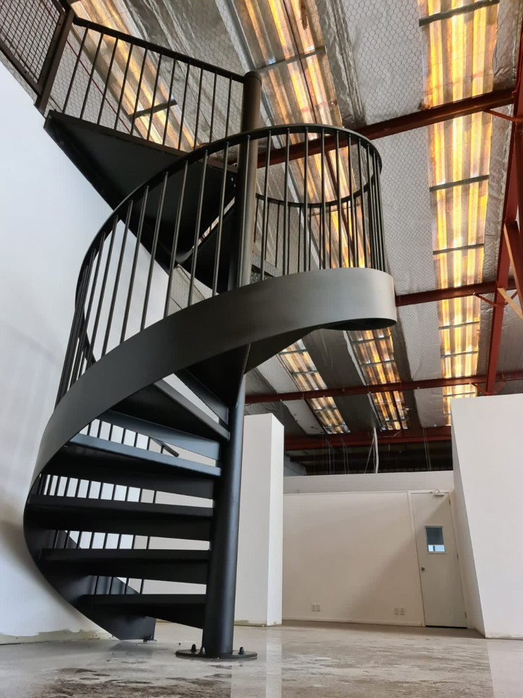 Inspiration for a mid-sized industrial metal spiral staircase in Auckland with open risers and metal railing.
