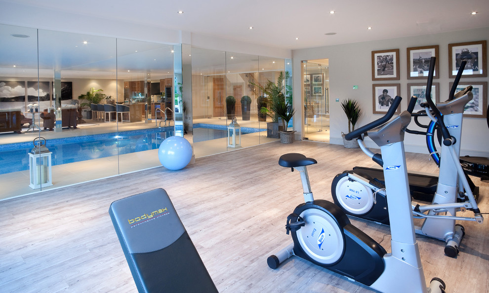 Photo of a traditional multipurpose gym in Berkshire with white walls and light hardwood floors.