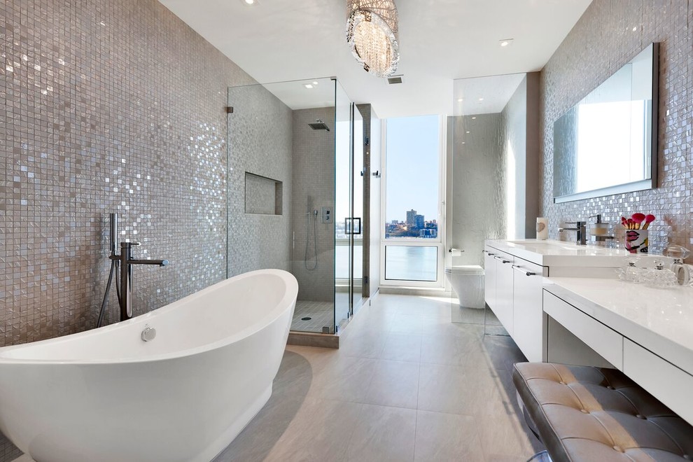 Contemporary master bathroom in New York with flat-panel cabinets, white cabinets, a freestanding tub, a corner shower and an undermount sink.