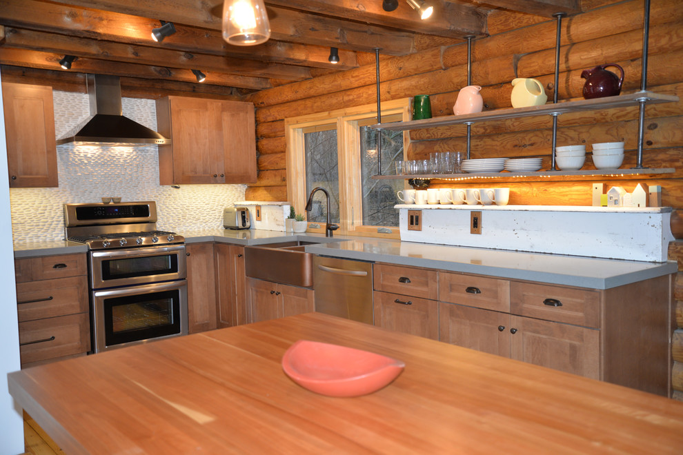 Mid-sized mountain style galley light wood floor open concept kitchen photo in Grand Rapids with an undermount sink, recessed-panel cabinets, medium tone wood cabinets, solid surface countertops, white backsplash, stainless steel appliances and an island