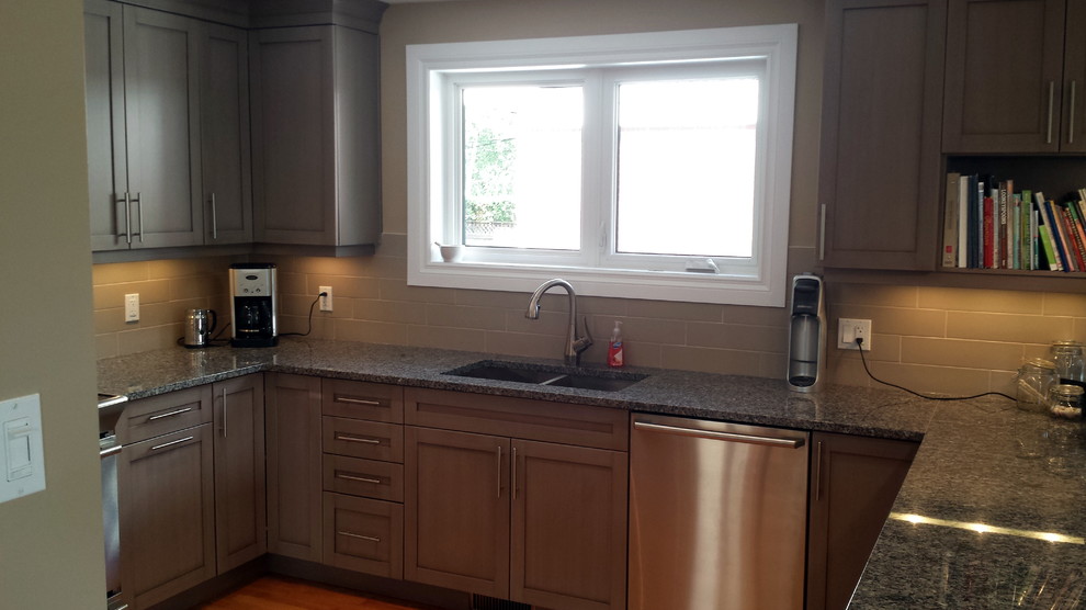 Open concept kitchen - large transitional u-shaped light wood floor open concept kitchen idea in Toronto with an undermount sink, shaker cabinets, gray cabinets, quartz countertops, beige backsplash, subway tile backsplash, stainless steel appliances and a peninsula