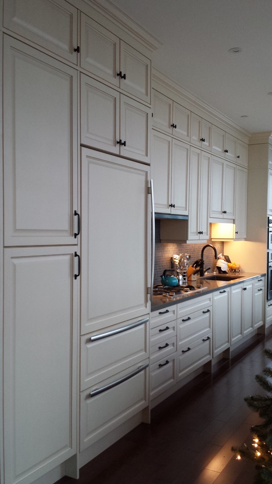 Inspiration for a mid-sized transitional galley dark wood floor open concept kitchen remodel in Toronto with a single-bowl sink, raised-panel cabinets, light wood cabinets, quartz countertops, black backsplash, cement tile backsplash, stainless steel appliances and an island
