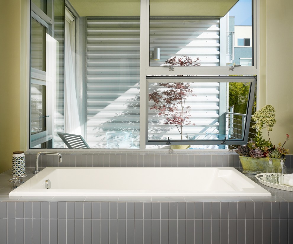 This is an example of an industrial bathroom in Los Angeles with a drop-in tub.