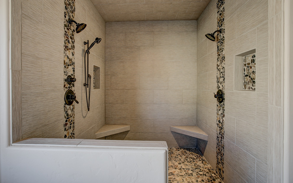 Photo of a mid-sized transitional master bathroom in Denver with raised-panel cabinets, medium wood cabinets, an alcove shower, beige tile, porcelain tile, beige walls, travertine floors, an undermount sink and granite benchtops.