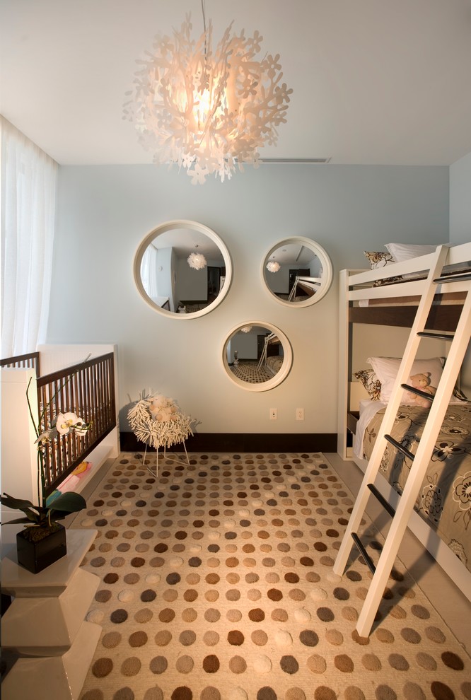 Contemporary gender-neutral nursery in Miami with grey walls and multi-coloured floor.