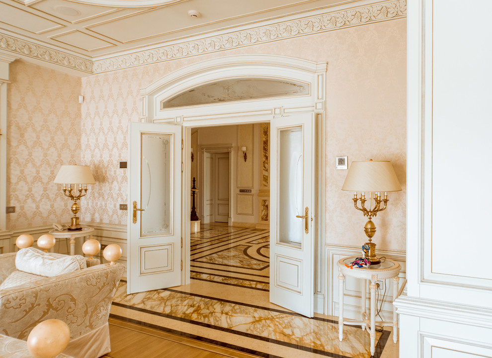 Photo of a large traditional formal open concept living room in Moscow with pink walls and marble floors.