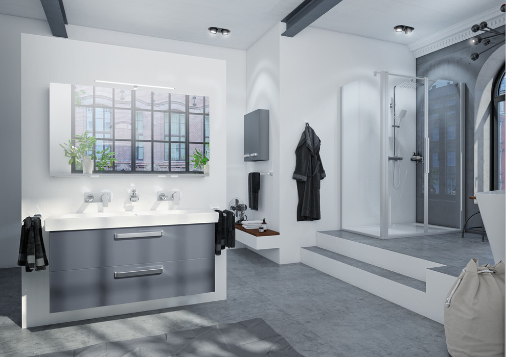 Geräumiges Industrial Duschbad mit flächenbündigen Schrankfronten, grauen Schränken, freistehender Badewanne, bodengleicher Dusche, Bidet, weißer Wandfarbe, Aufsatzwaschbecken, grauem Boden, Falttür-Duschabtrennung und Betonboden in Hannover
