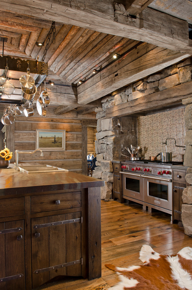 Country kitchen in Other with stainless steel appliances.