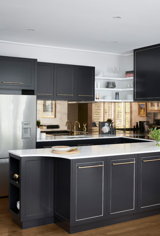Design ideas for a large traditional u-shaped kitchen pantry in Melbourne with a double-bowl sink, raised-panel cabinets, black cabinets, marble benchtops, metallic splashback, glass tile splashback, coloured appliances, plywood floors, with island, brown floor and white benchtop.