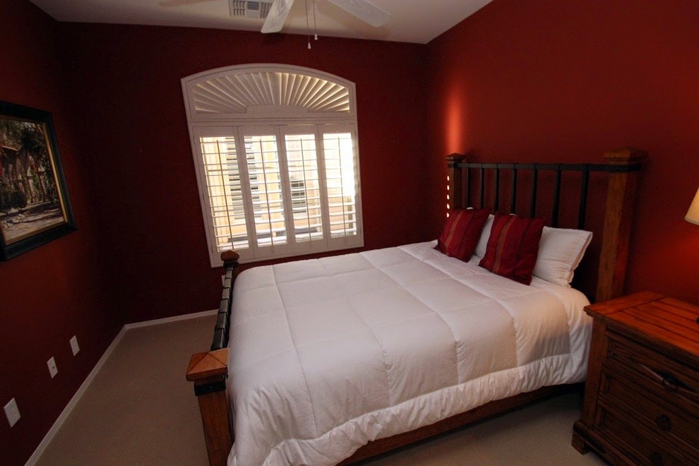 This is an example of a traditional bedroom in Phoenix with red walls.