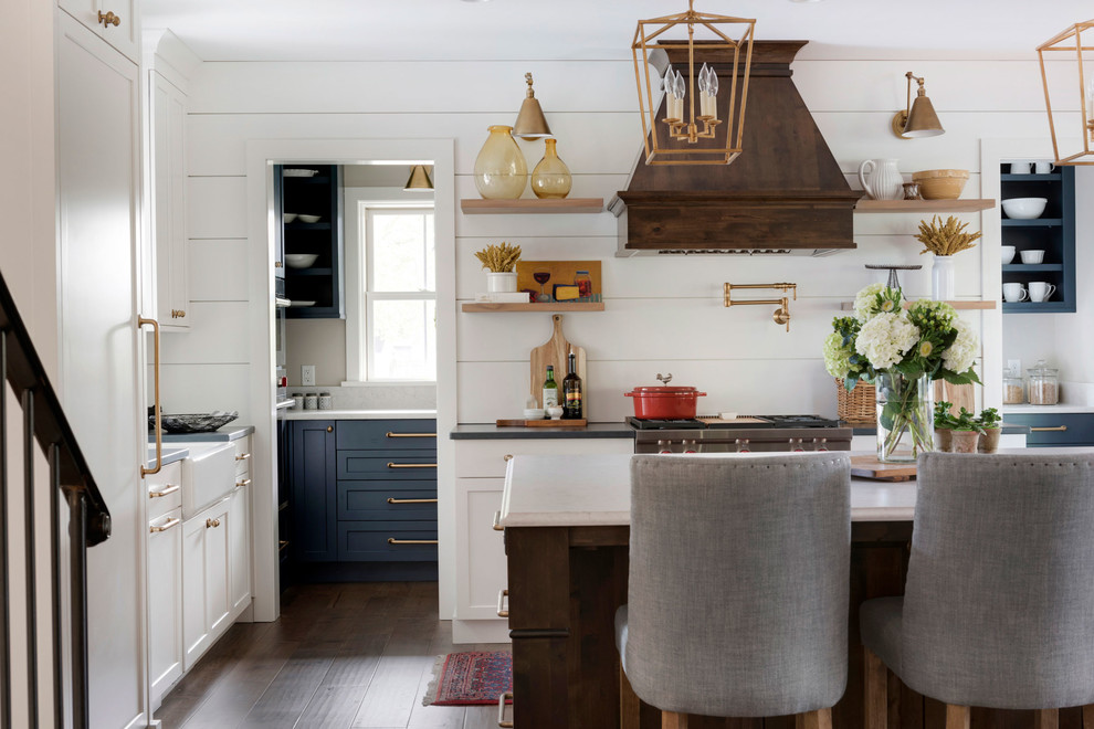 Large country eat-in kitchen in Minneapolis with a farmhouse sink, stainless steel appliances, with island and shiplap splashback.