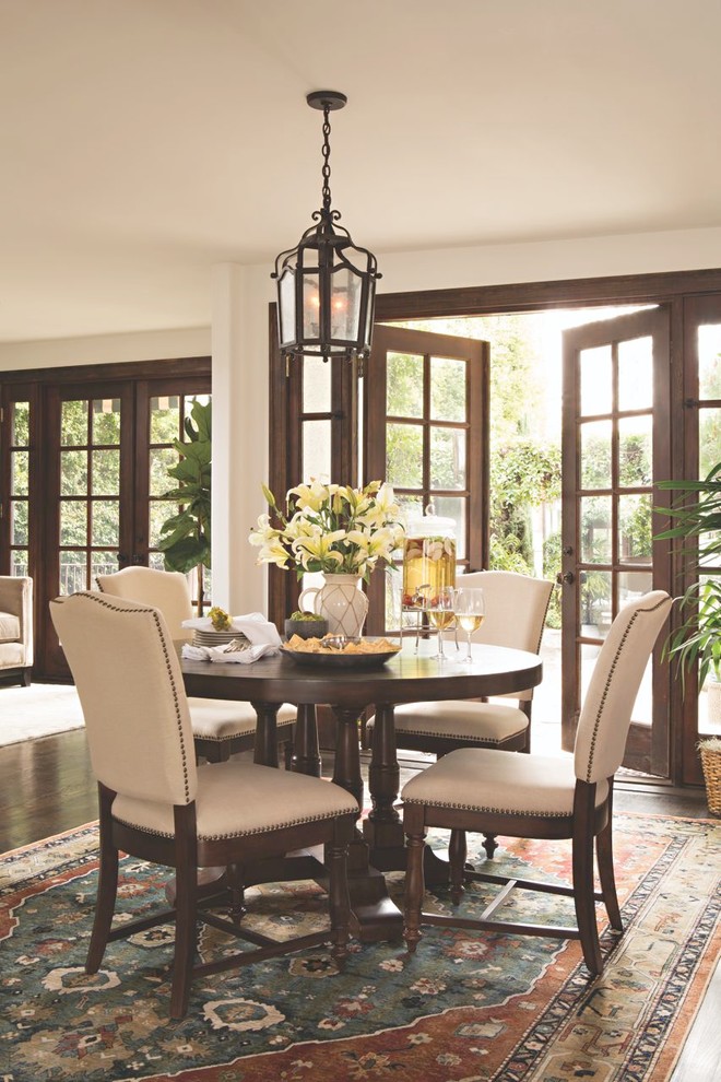 Mid-sized traditional separate dining room in Los Angeles with white walls, medium hardwood floors and no fireplace.