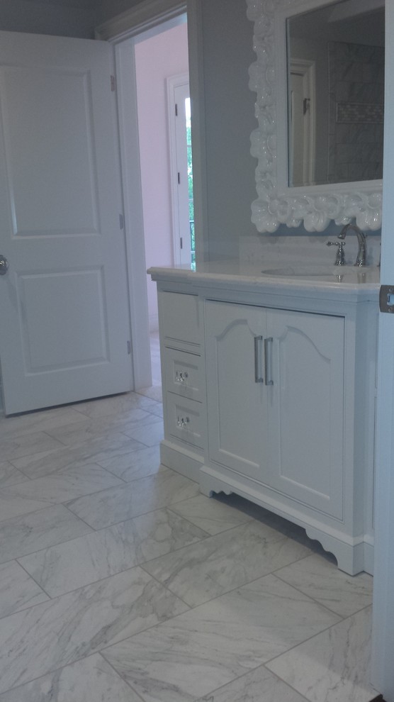 Bathroom - large transitional master marble floor and white floor bathroom idea with recessed-panel cabinets, white cabinets, gray walls, an undermount sink and marble countertops