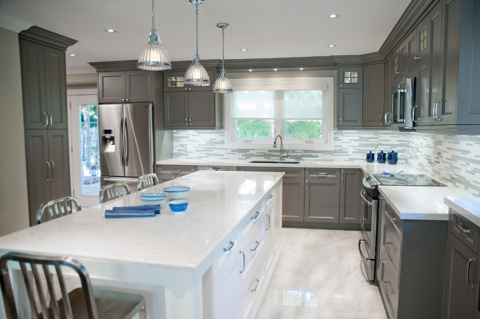Mid-sized transitional u-shaped kitchen in Toronto with an undermount sink, shaker cabinets, grey cabinets, quartz benchtops, yellow splashback, mosaic tile splashback, stainless steel appliances, marble floors and with island.
