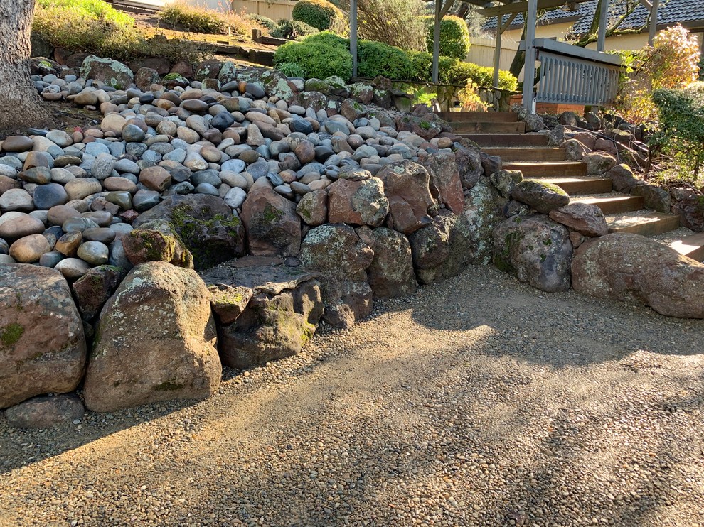 Photo of a mid-sized country backyard partial sun garden in Sacramento with gravel.