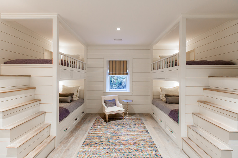 Inspiration for a mid-sized beach style guest bedroom in Boston with white walls, light hardwood floors and no fireplace.