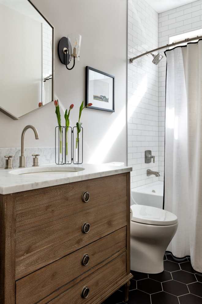 Inspiration for a mid-sized transitional kids bathroom in Seattle with furniture-like cabinets, brown cabinets, a one-piece toilet, white tile, white walls, marble benchtops, black floor, white benchtops, a single vanity and a freestanding vanity.