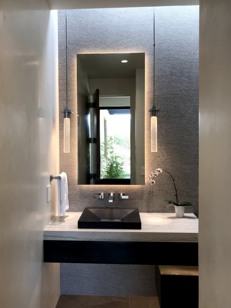 Design ideas for a large midcentury powder room in Albuquerque with flat-panel cabinets, black cabinets, beige tile, porcelain tile, white walls, porcelain floors, an undermount sink, granite benchtops, grey floor and grey benchtops.
