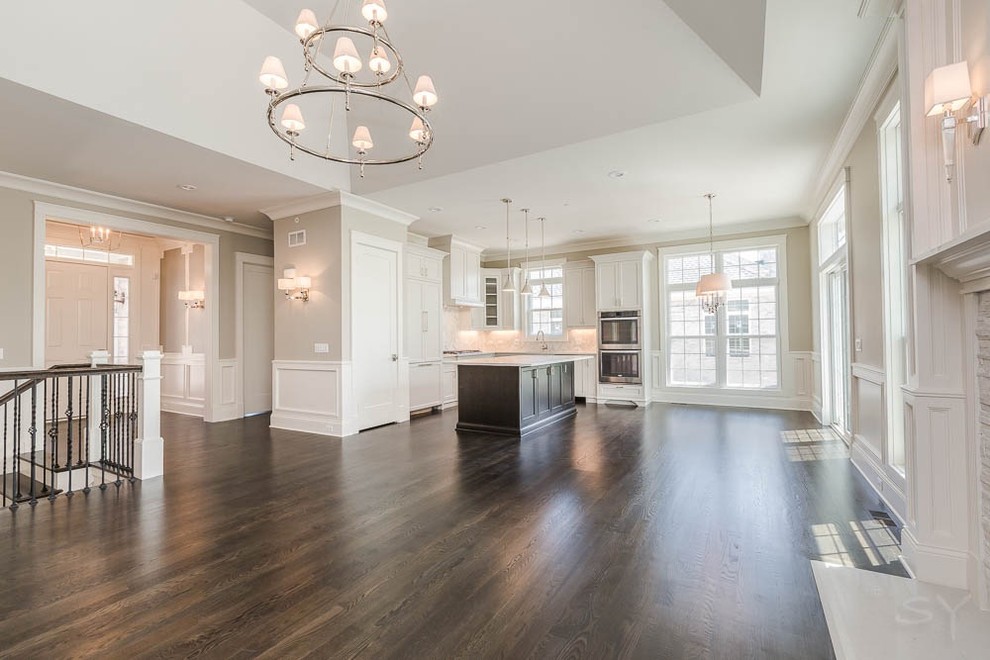 Eat-in kitchen - mid-sized transitional l-shaped dark wood floor eat-in kitchen idea in Chicago with shaker cabinets, white cabinets, gray backsplash, stone tile backsplash, stainless steel appliances and an island