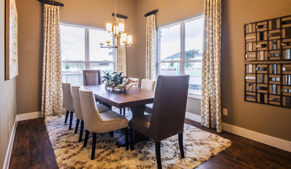This is an example of a large midcentury separate dining room in Austin with beige walls and medium hardwood floors.