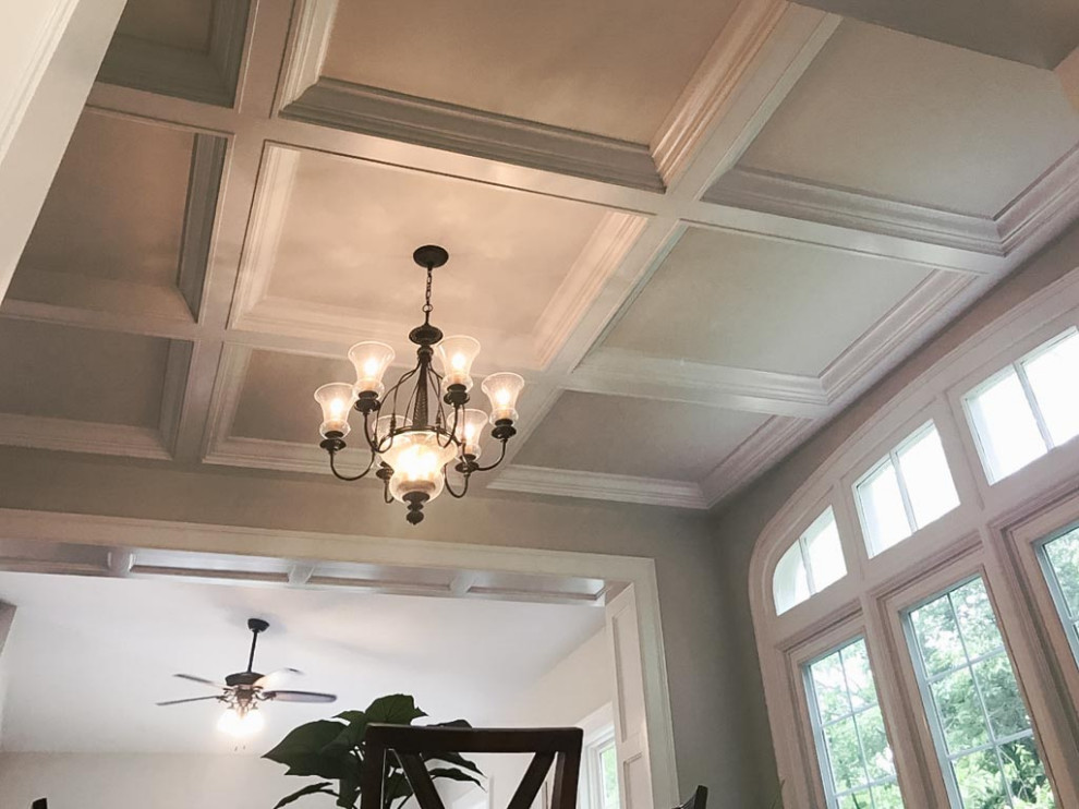 This is an example of a traditional enclosed family room in Cleveland with grey walls, dark hardwood floors, brown floor and coffered.
