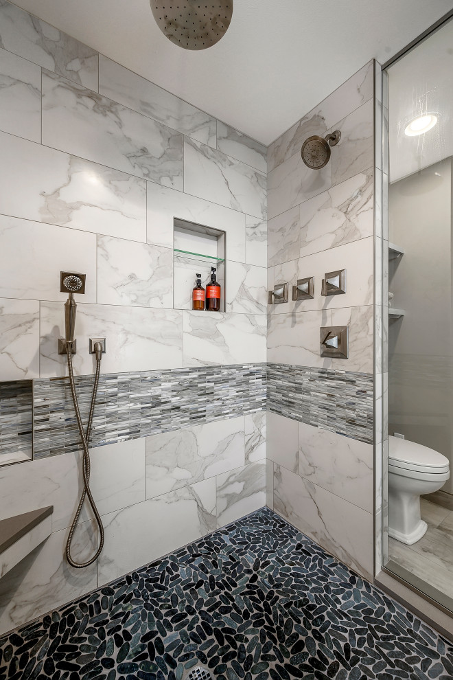 Design ideas for a mid-sized transitional master wet room bathroom in Seattle with shaker cabinets, blue cabinets, a freestanding tub, a two-piece toilet, multi-coloured tile, porcelain tile, beige walls, porcelain floors, an undermount sink, engineered quartz benchtops, grey floor, an open shower and grey benchtops.