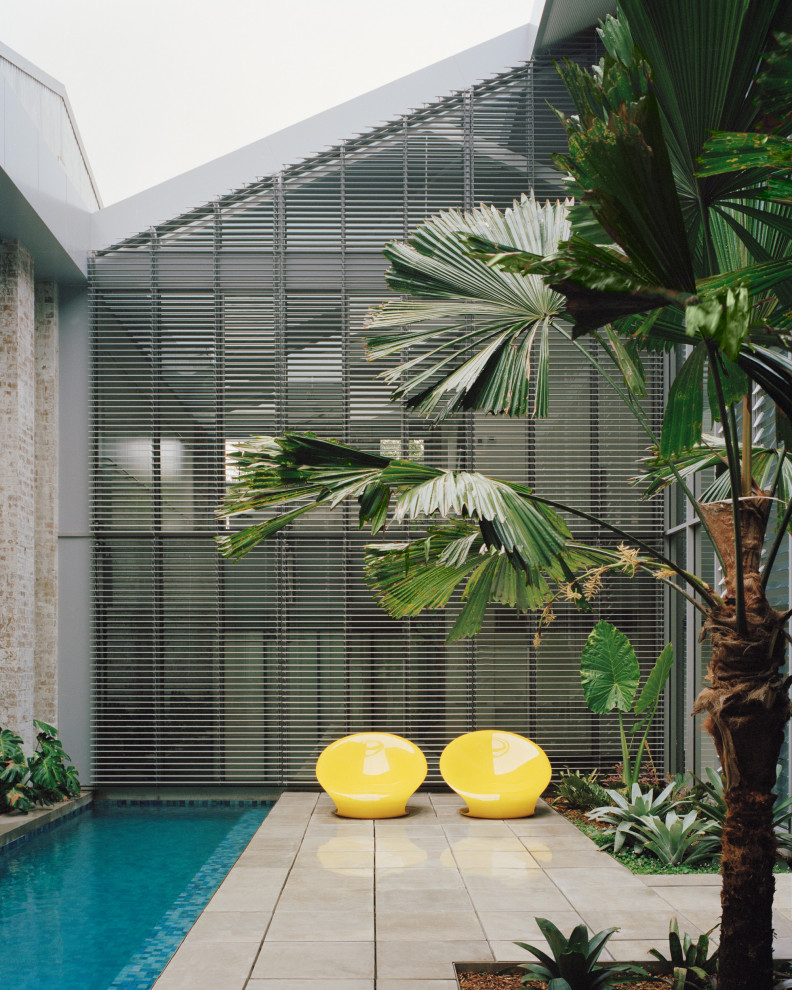 Inspiration for an industrial rectangular lap pool in Sydney with tile.