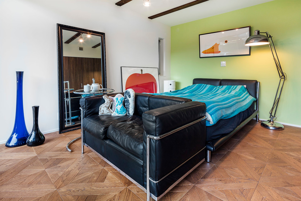 This is an example of a contemporary bedroom in Other with multi-coloured walls, medium hardwood floors and brown floor.