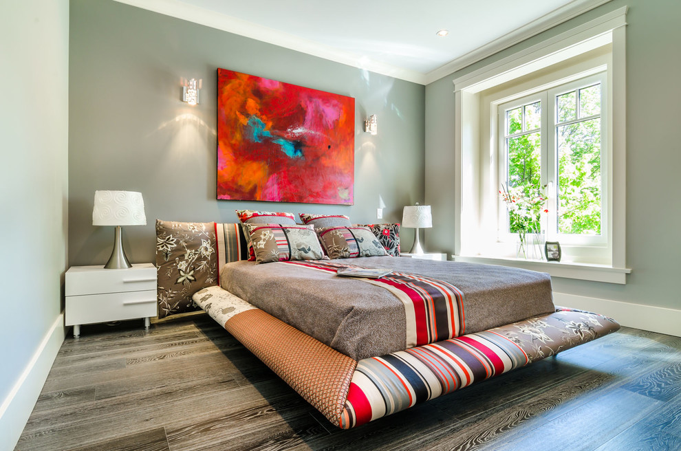 Design ideas for a contemporary bedroom in Vancouver with grey walls, medium hardwood flooring and a feature wall.