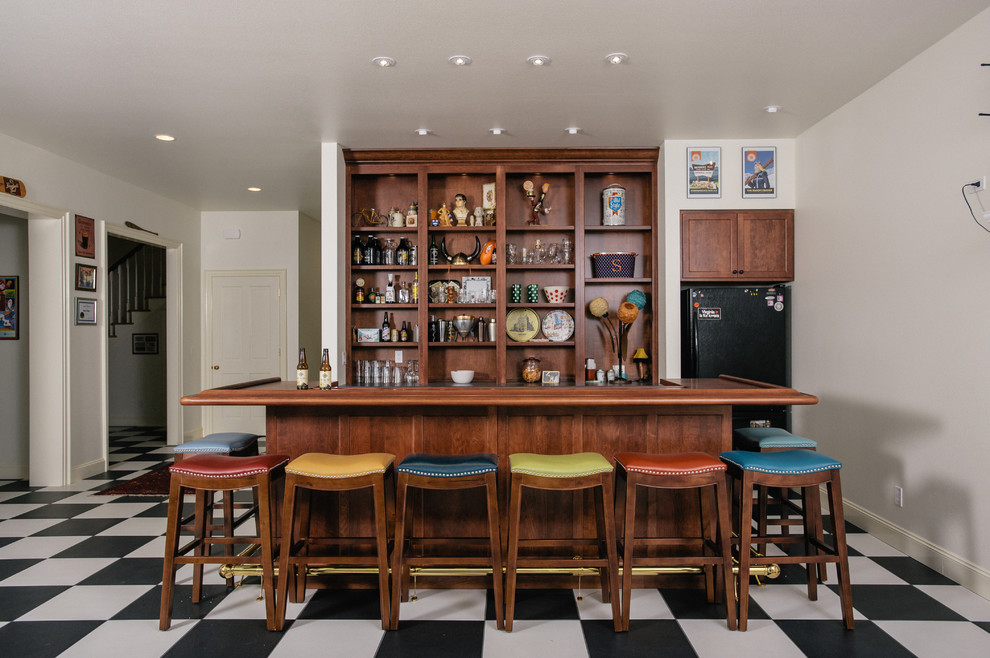 This is an example of a traditional home bar in Denver with brown benchtop.