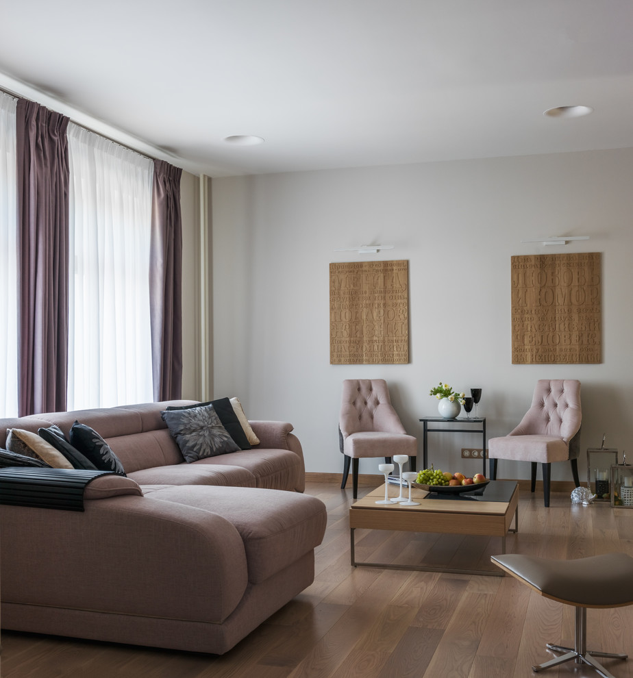 This is an example of a contemporary living room in Moscow with white walls, medium hardwood floors and brown floor.
