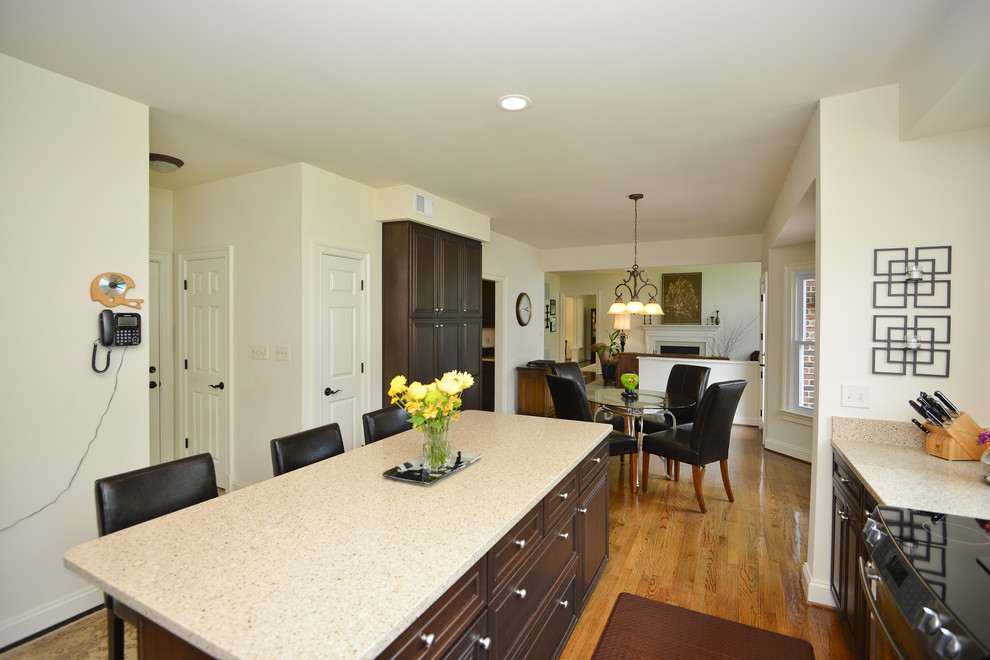 Inspiration for a l-shaped dark wood floor eat-in kitchen remodel in DC Metro with raised-panel cabinets, dark wood cabinets, quartz countertops and an island