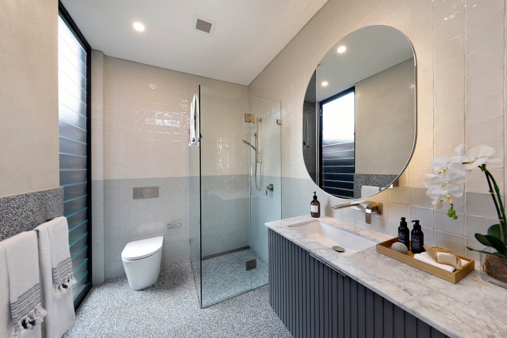 Photo of a mid-sized contemporary 3/4 bathroom in Sydney with furniture-like cabinets, grey cabinets, an undermount tub, multi-coloured tile, multi-coloured walls, terrazzo floors, an undermount sink, marble benchtops, white benchtops, a single vanity, a floating vanity and coffered.