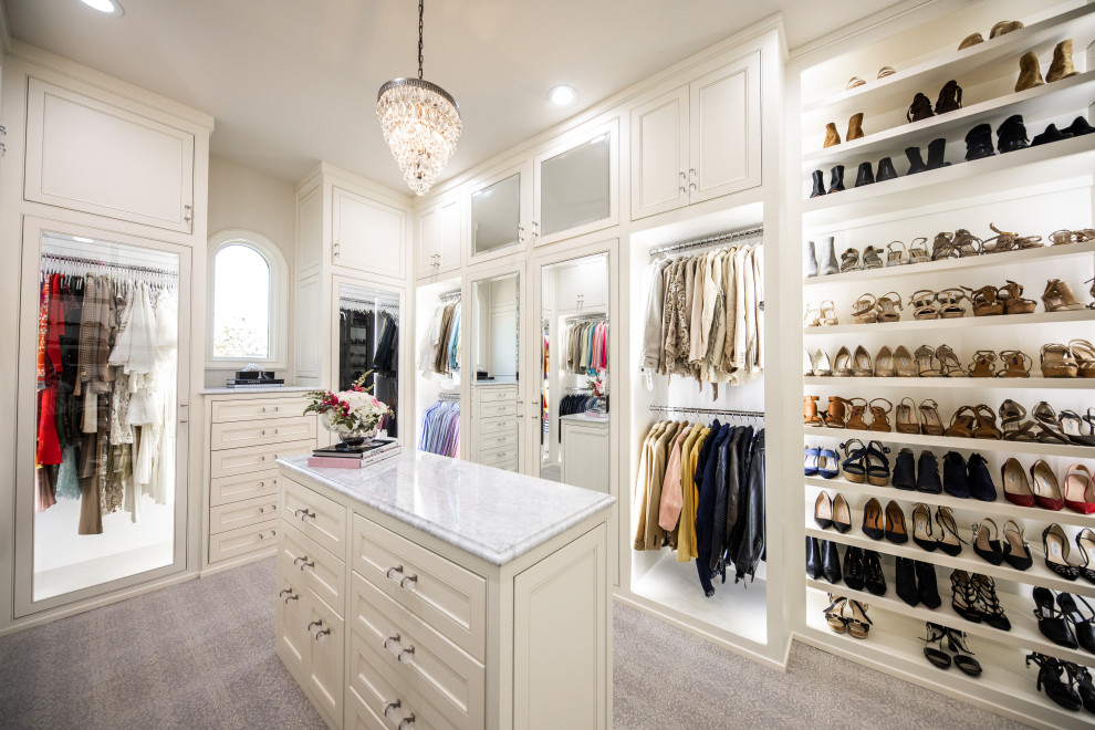 Photo of a transitional women's storage and wardrobe in Dallas with beaded inset cabinets, white cabinets and white floor.