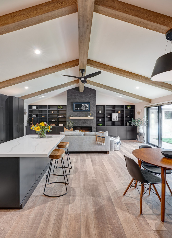 Design ideas for a small contemporary l-shaped open plan kitchen in Sacramento with an undermount sink, shaker cabinets, black cabinets, multi-coloured splashback, ceramic splashback, panelled appliances, vinyl floors, with island, brown floor, grey benchtop and exposed beam.