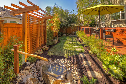 A high white lattice fence punctuates this well kept garden.