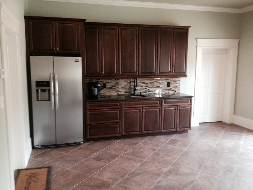 Inspiration for a large transitional single-wall terra-cotta tile home design remodel in Charlotte with an undermount sink, raised-panel cabinets, dark wood cabinets, granite countertops, multicolored backsplash, subway tile backsplash, stainless steel appliances and no island