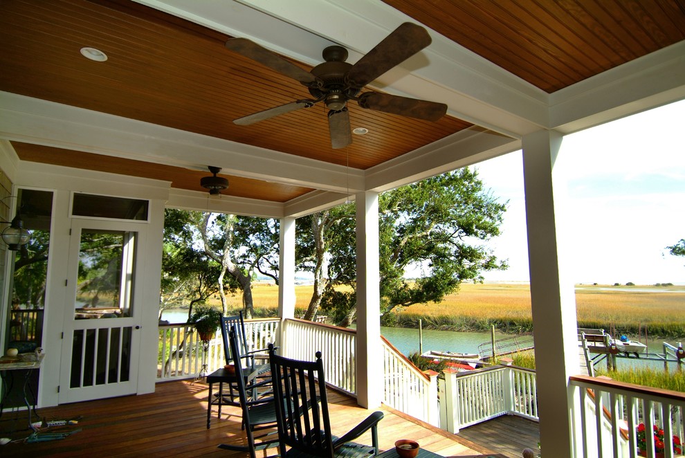 Photo of a mid-sized transitional backyard verandah in Charleston with decking, a roof extension and wood railing.