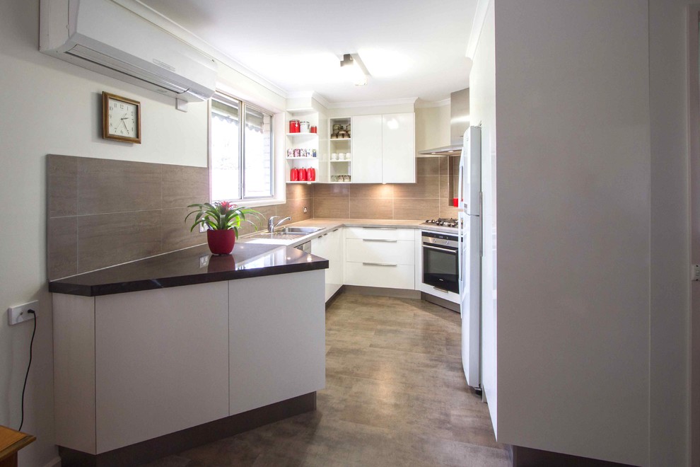 Photo of a small contemporary u-shaped separate kitchen in Melbourne with flat-panel cabinets, white cabinets, laminate benchtops, porcelain splashback, vinyl floors and no island.
