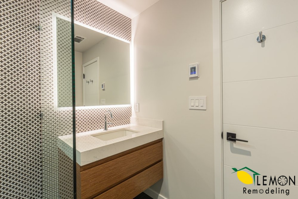 Example of a minimalist 3/4 black and white tile and ceramic tile ceramic tile and single-sink bathroom design in San Francisco with brown cabinets, an undermount sink, marble countertops, a hinged shower door, white countertops, a niche and a floating vanity