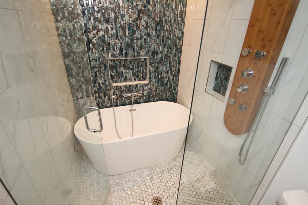Mid-sized minimalist master blue tile and mosaic tile porcelain tile, gray floor and double-sink bathroom photo in Atlanta with flat-panel cabinets, medium tone wood cabinets, a one-piece toilet, white walls, an integrated sink, quartz countertops, a hinged shower door, white countertops, a niche and a floating vanity
