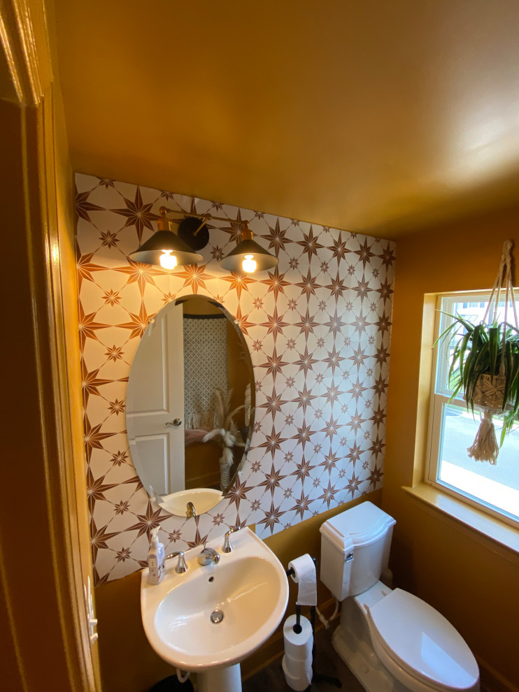 This is an example of a transitional powder room in DC Metro with brown tile and a freestanding vanity.